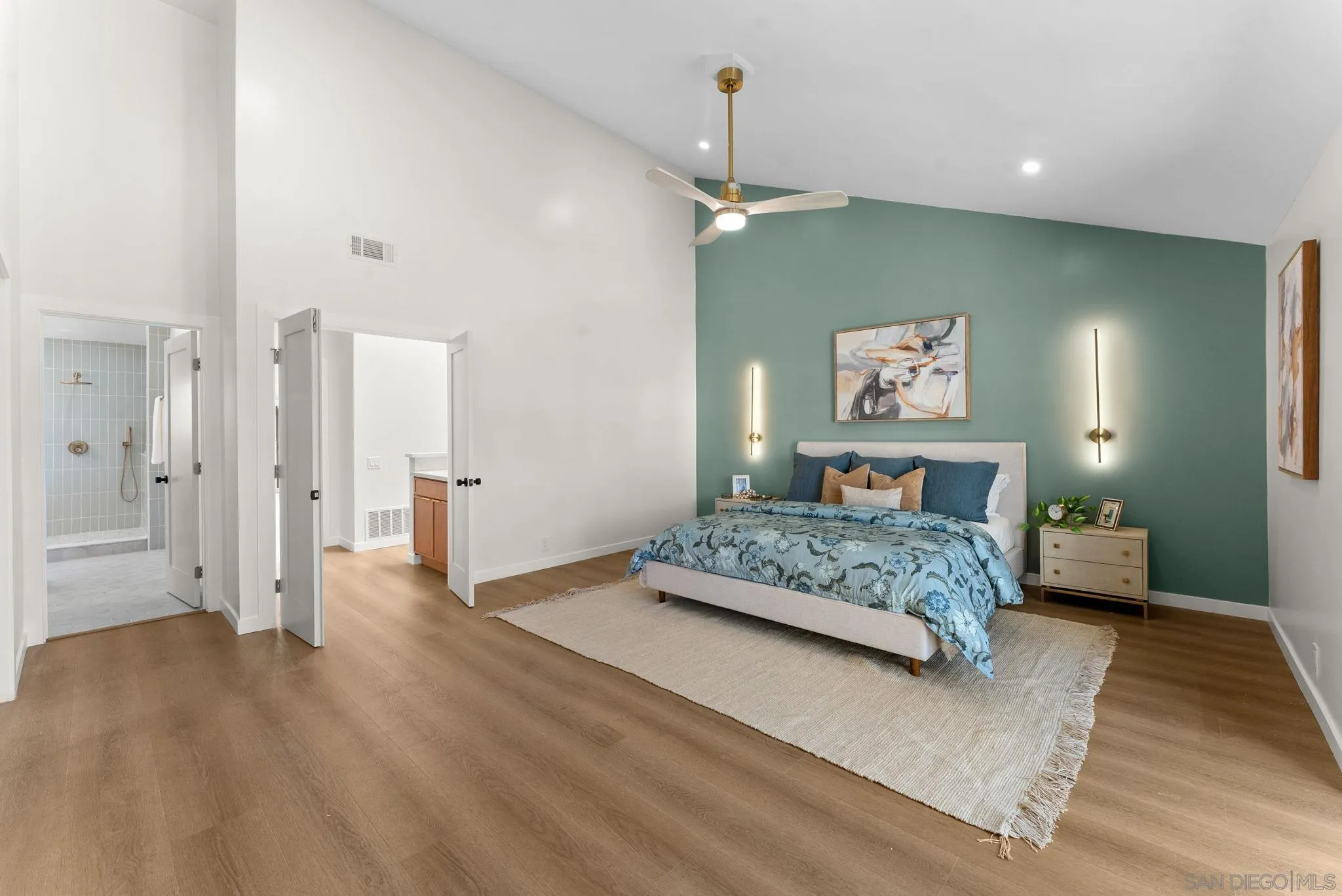 16048 Via Viajera Rancho Santa Fe, CA 92091 - Photo 19 of 46 a spacious bedroom with a bed and a chandelier