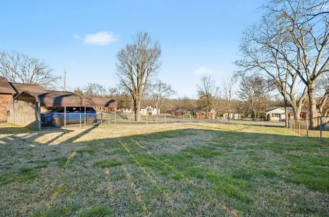 a view of outdoor space with garden and trees