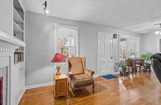 a living room with furniture and wooden floor