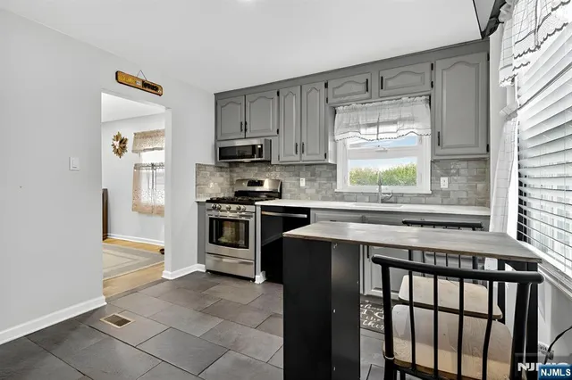 a kitchen with a stove a sink and a refrigerator