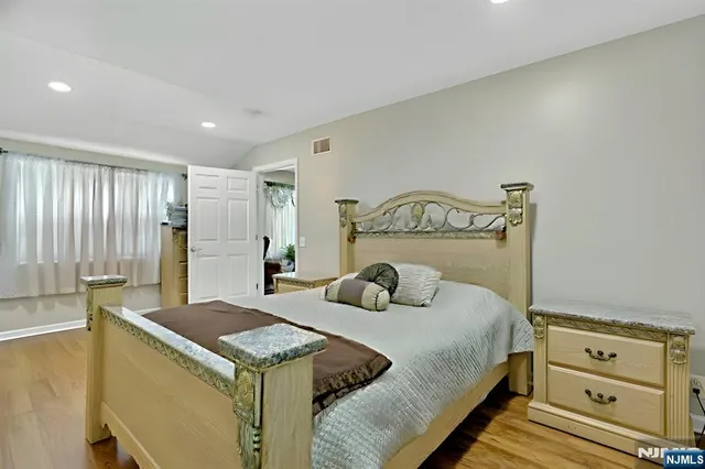 a bedroom with a bed and a dresser