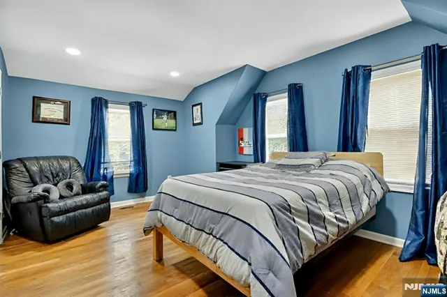 a bedroom with a bed couch and window