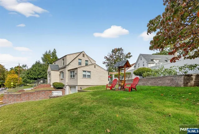 a view of a house with a yard porch and sitting area
