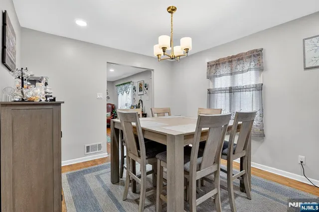 a view of a dining room with furniture wooden floor and chandelier