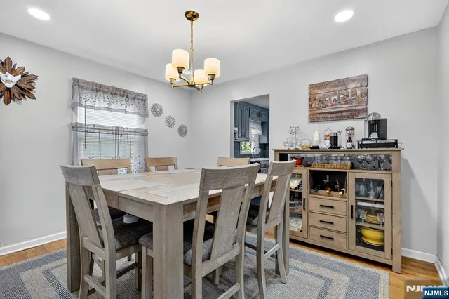 a view of a dining room with furniture and chandelier