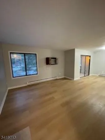 a view of an empty room with windows