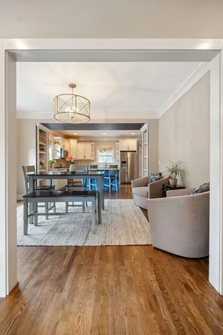 a living room with furniture and view of kitchen