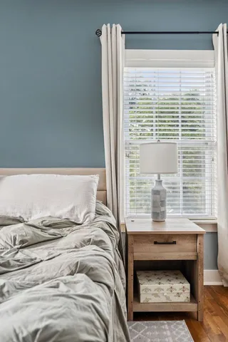 a bedroom with a bed and a window