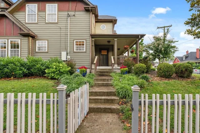 a front view of a house with a garden