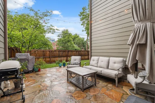 a building outdoor space with patio furniture and potted plants