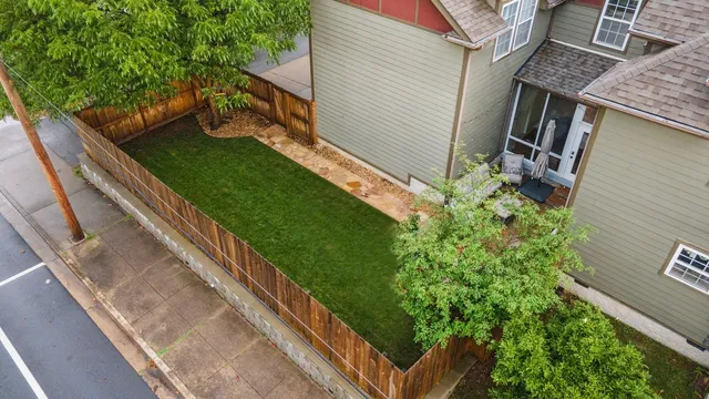 an aerial view of a house with a garden and trees