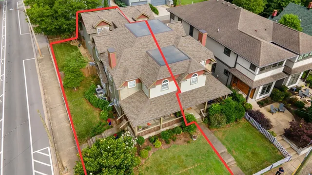 an aerial view of a house with a garden and trees
