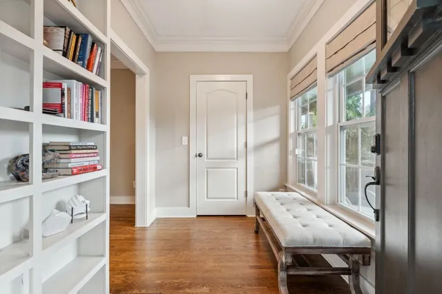 a view of a workspace with furniture and a book shelf