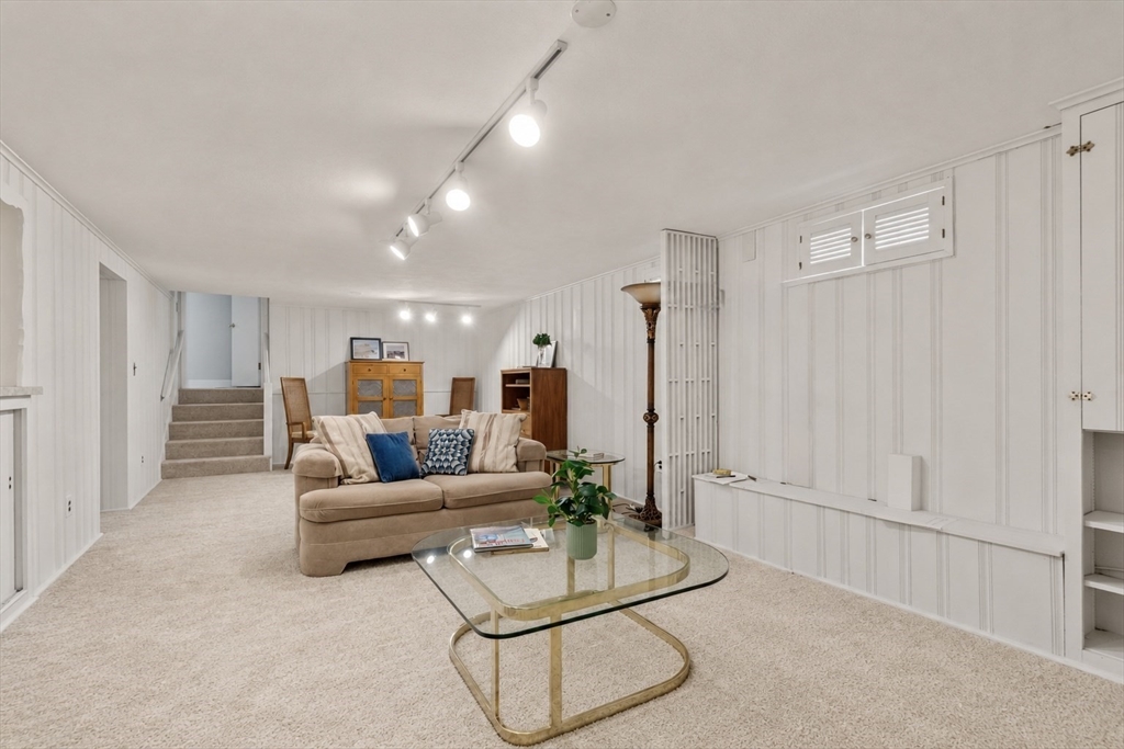 83 Bound Brook Road Newton, MA 02461 - Photo 10 of 21 a living room with furniture a ceiling fan and a rug