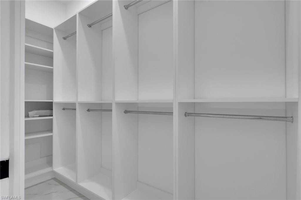 491 9th Street Southwest Naples, FL 34117 - Photo 15 of 49 a view of walk in closet with empty racks
