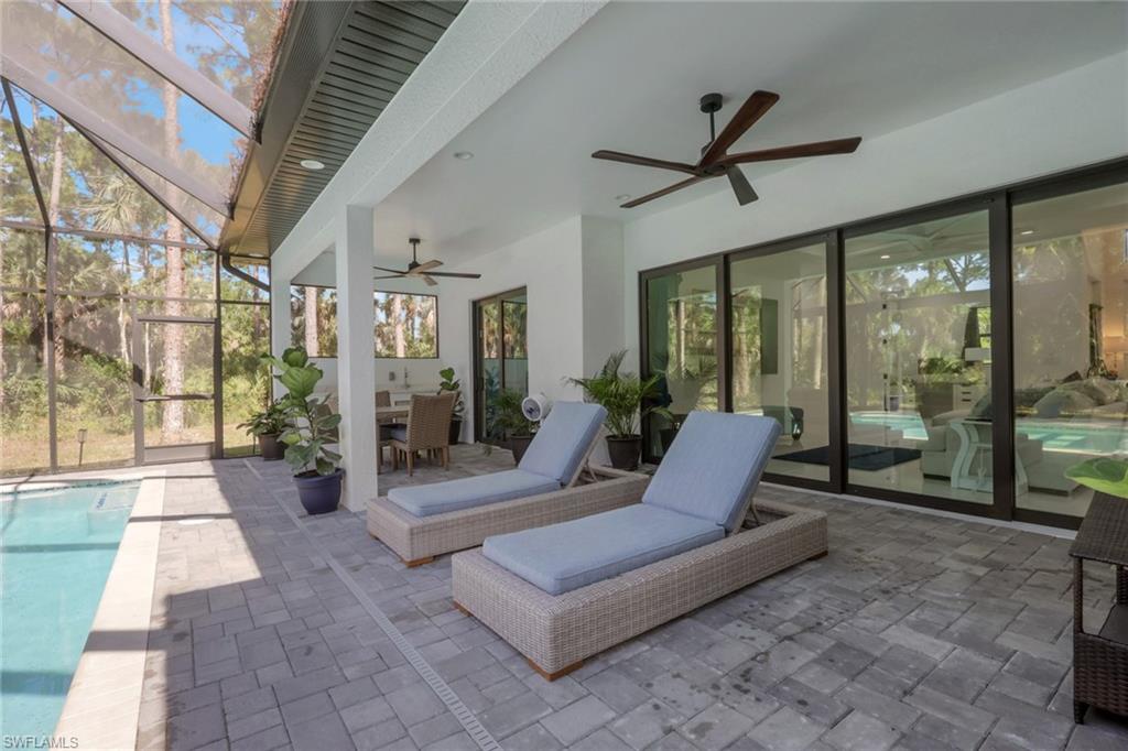 491 9th Street Southwest Naples, FL 34117 - Photo 27 of 49 a outdoor space with patio the couches and a dining table with garden view
