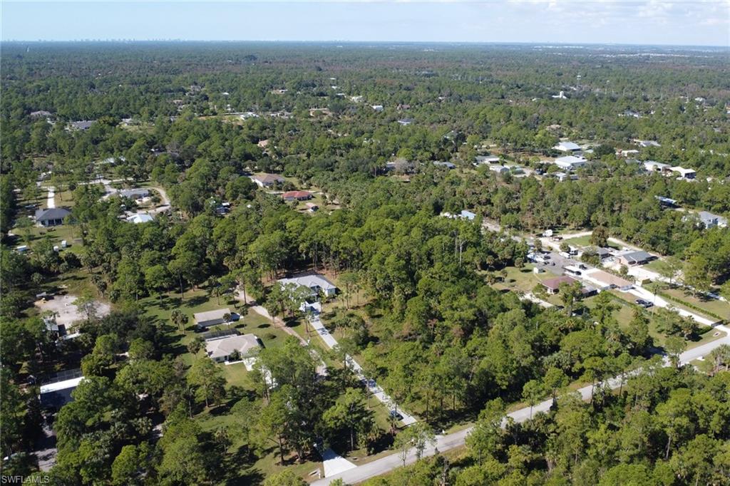 491 9th Street Southwest Naples, FL 34117 - Photo 39 of 49 an aerial view of town with residential houses with green space and mountain view