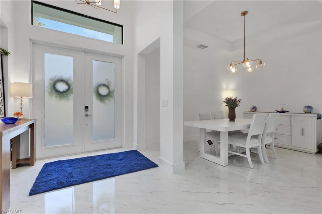 491 9th Street Southwest Naples, FL 34117 - Photo 4 of 49 a view of a dining room with furniture and wooden floor