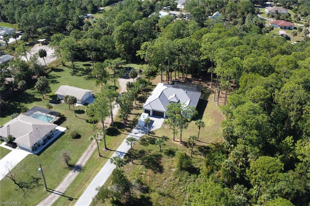 491 9th Street Southwest Naples, FL 34117 - Photo 43 of 49 an aerial view of residential houses with outdoor space and trees