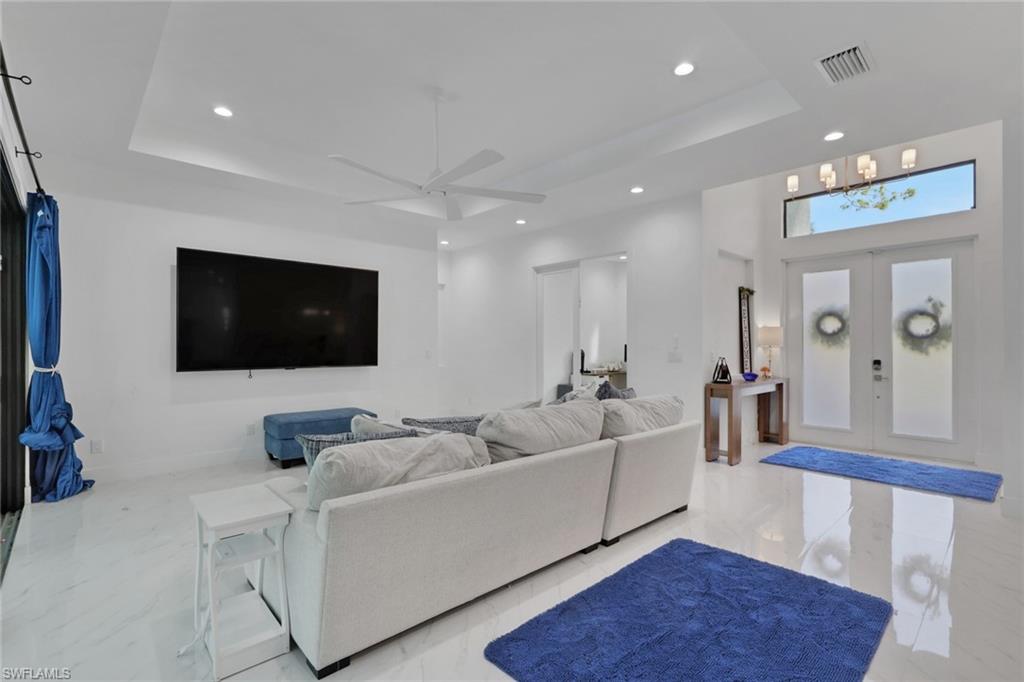 491 9th Street Southwest Naples, FL 34117 - Photo 5 of 49 a living room with furniture and a flat screen tv