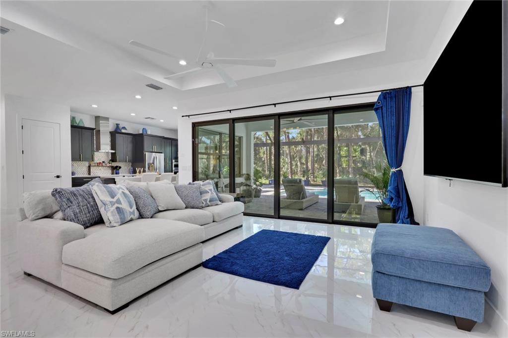 491 9th Street Southwest Naples, FL 34117 - Photo 7 of 49 a living room with furniture and a large window