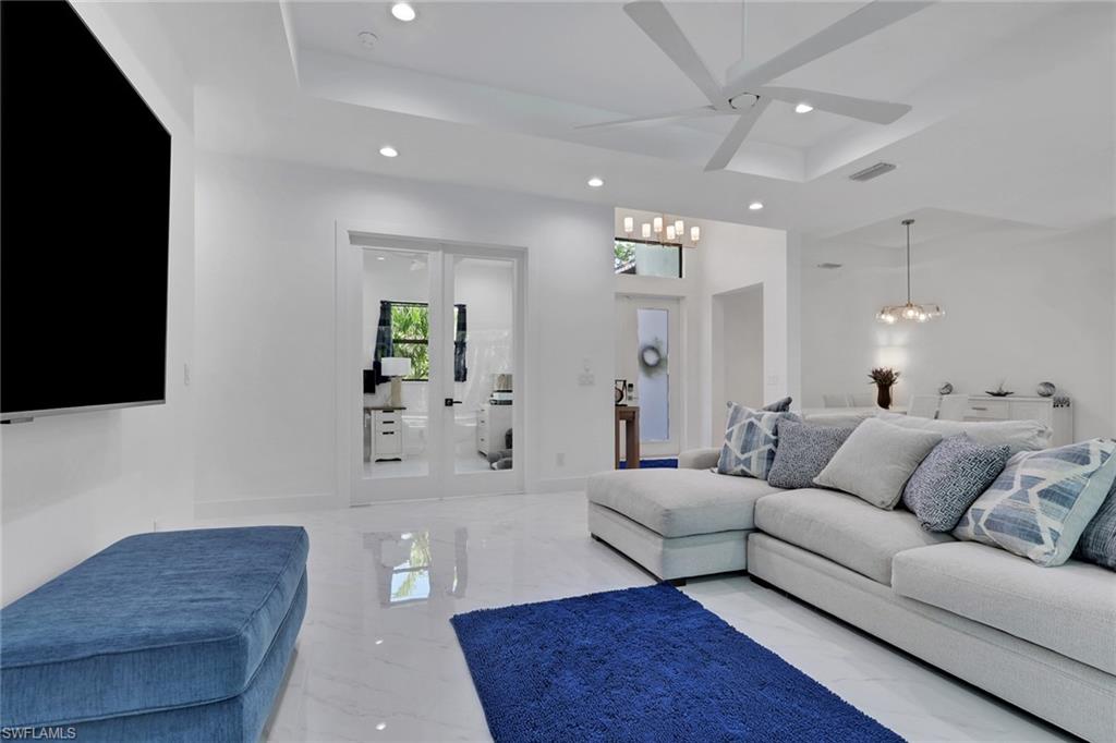 491 9th Street Southwest Naples, FL 34117 - Photo 8 of 49 a living room with furniture and a flat screen tv