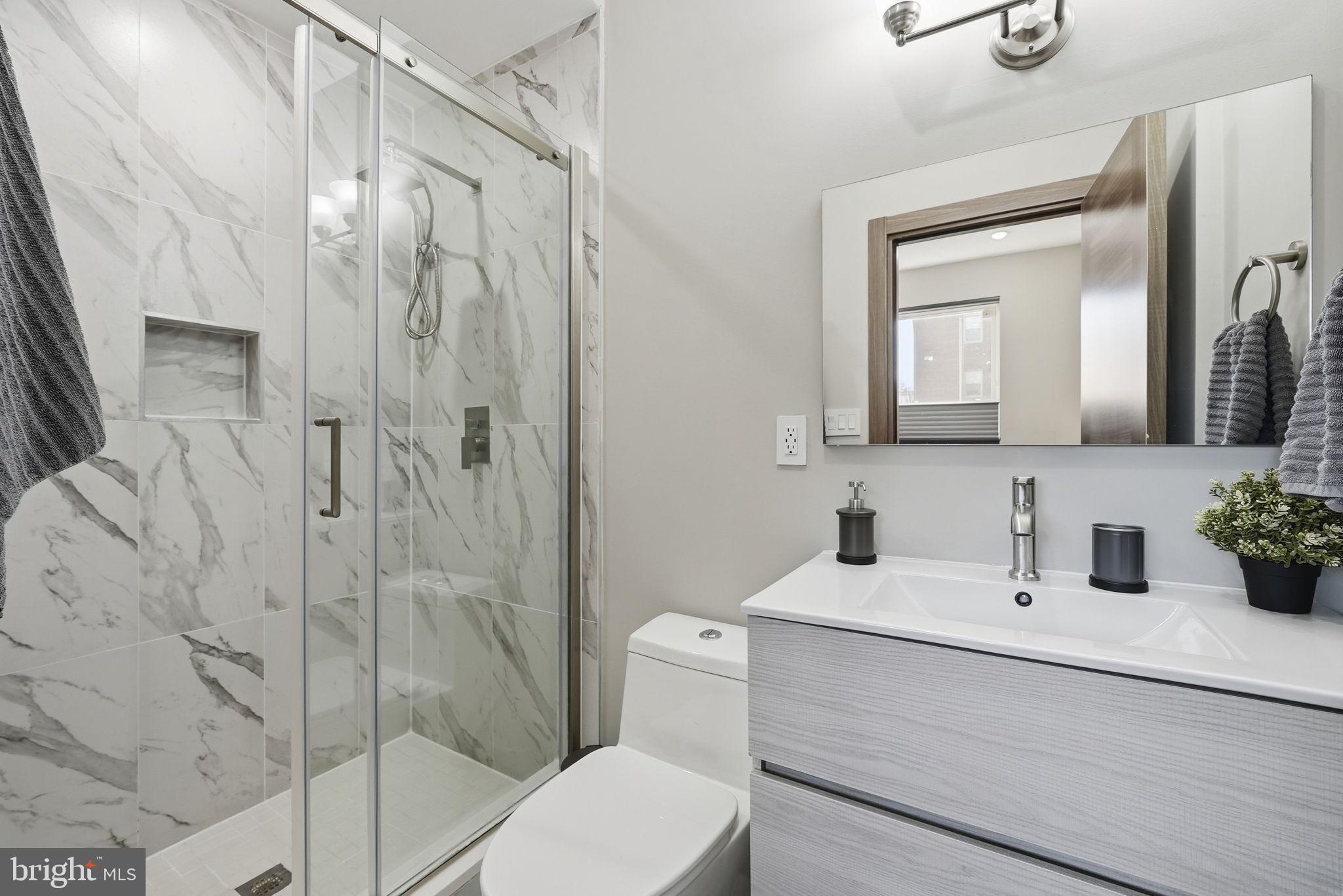 2109 M Street Northeast, Unit 5 Washington, DC 20002 - Photo 7 of 11 a bathroom with a sink a toilet and shower