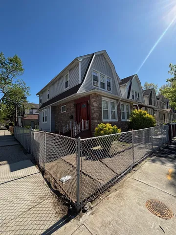 a front view of a house with iron fence
