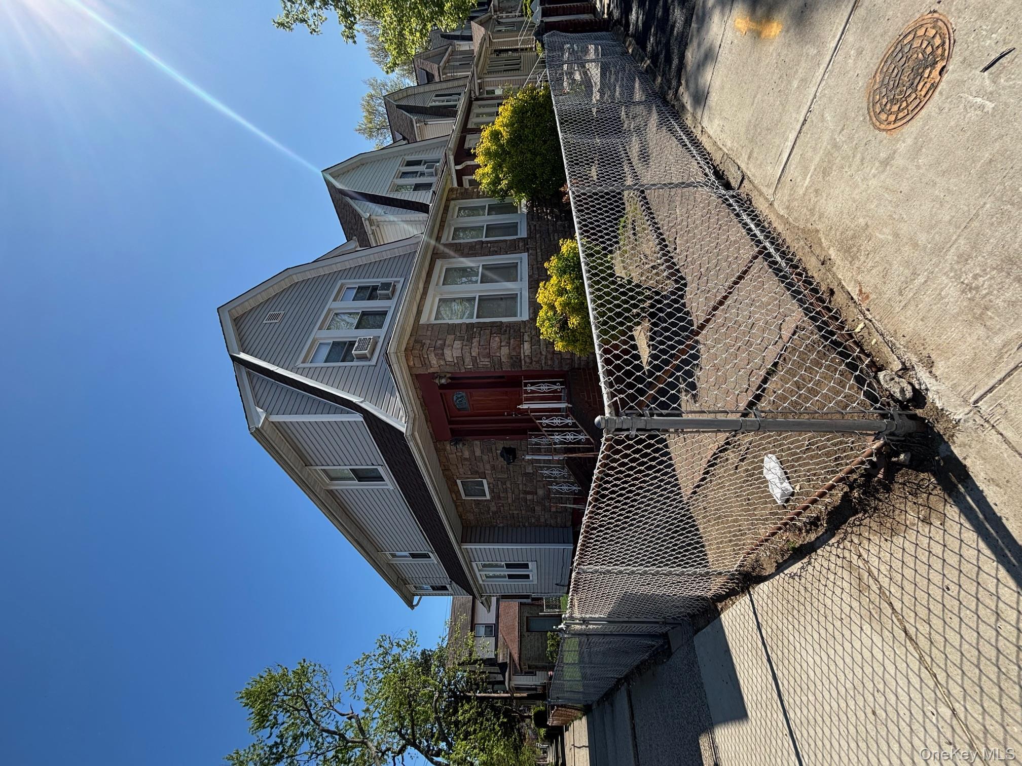 a front view of a house with iron fence
