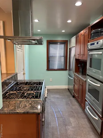 a kitchen with granite countertop a stove and a sink