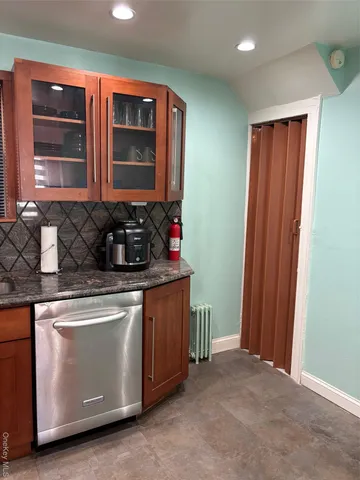 a kitchen with granite countertop a stove and a sink