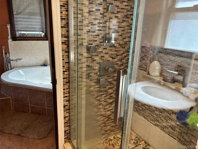 a bathroom with a sink a mirror and shower