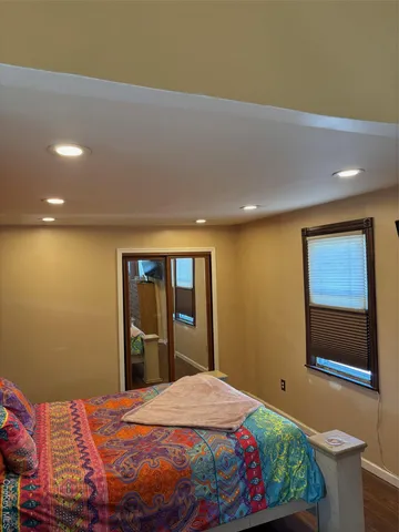 a bedroom with a bed and dresser