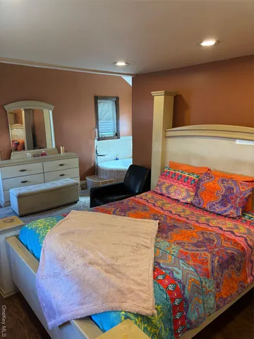 a bedroom with a bed and a dresser