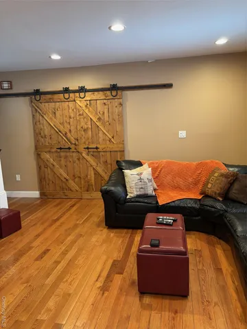 a bed sitting in a room next to a lamp