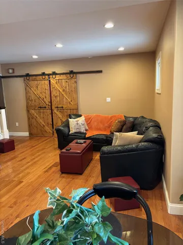 a living room with furniture and wooden floor