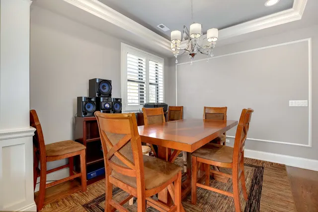 a view of a dining room with furniture and chandelier