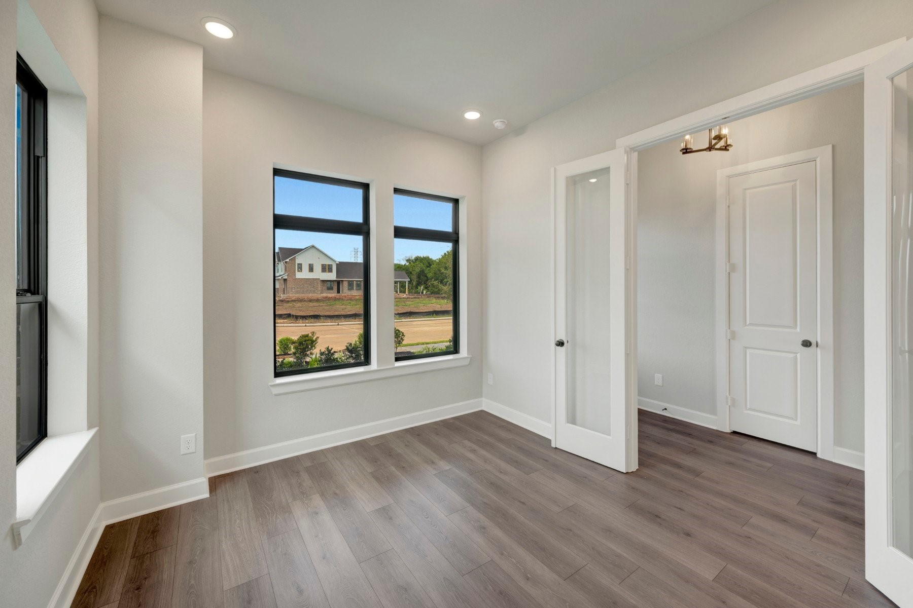 2722 Cottage Place Rosharon, TX 77583 - Photo 15 of 50 a view of an empty room with wooden floor and a window
