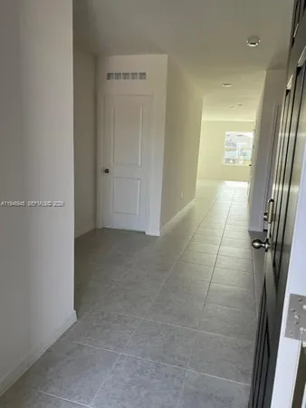 an empty room with wooden floor and a window