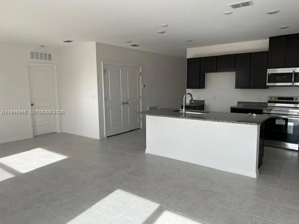 a view of a kitchen with appliances