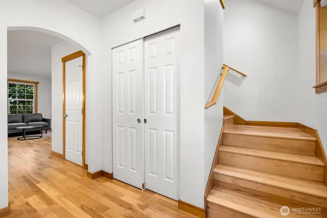 a view of a livingroom with wooden floor and stairs