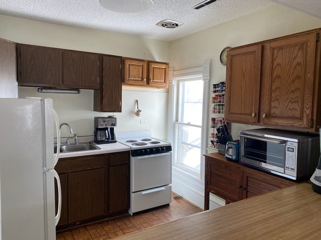 986 Main Street Antioch, IL 60002 - Photo 15 of 24 a kitchen with stainless steel appliances granite countertop a refrigerator stove and sink