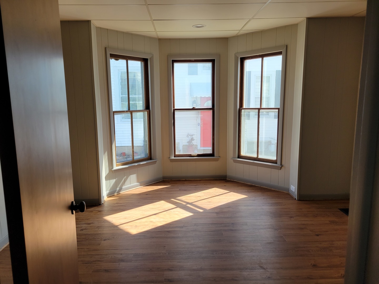 986 Main Street Antioch, IL 60002 - Photo 8 of 24 an empty room with wooden floor and windows