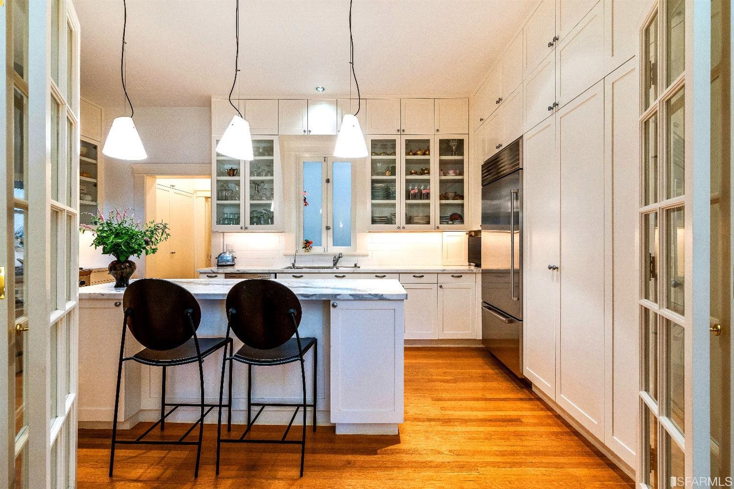 1925 Gough Street, Unit 11 San Francisco, CA 94109 - Photo 14 of 46 a kitchen with granite countertop a counter space chairs stainless steel appliances and cabinets