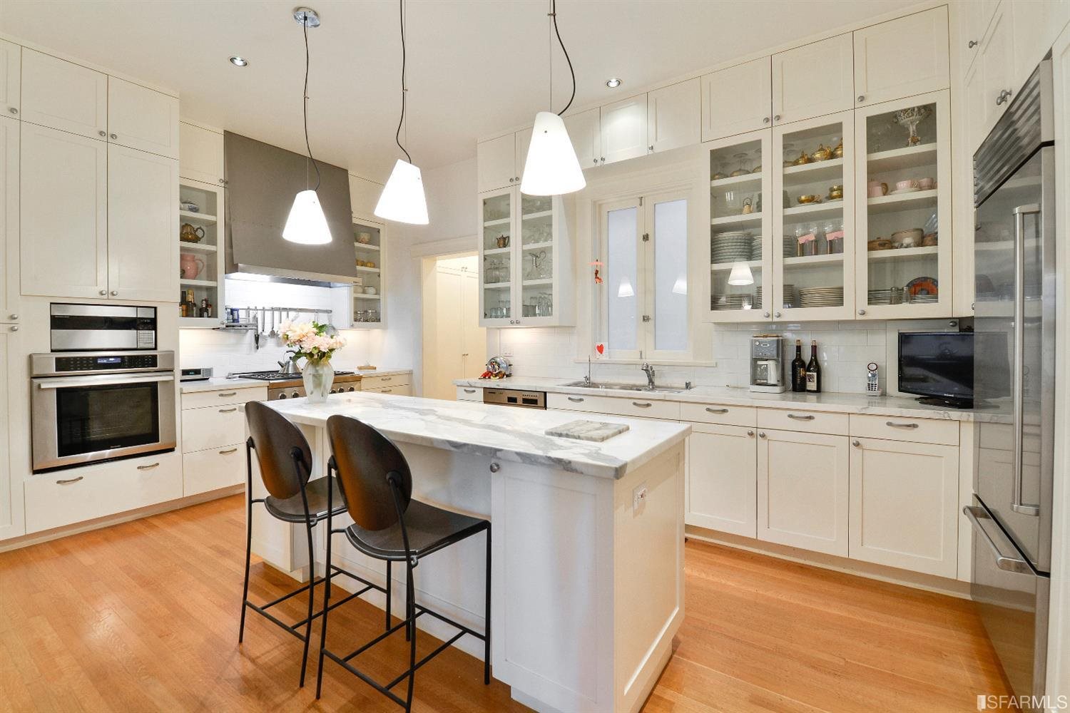 1925 Gough Street, Unit 11 San Francisco, CA 94109 - Photo 15 of 46 a kitchen with stainless steel appliances granite countertop a stove a sink and a refrigerator