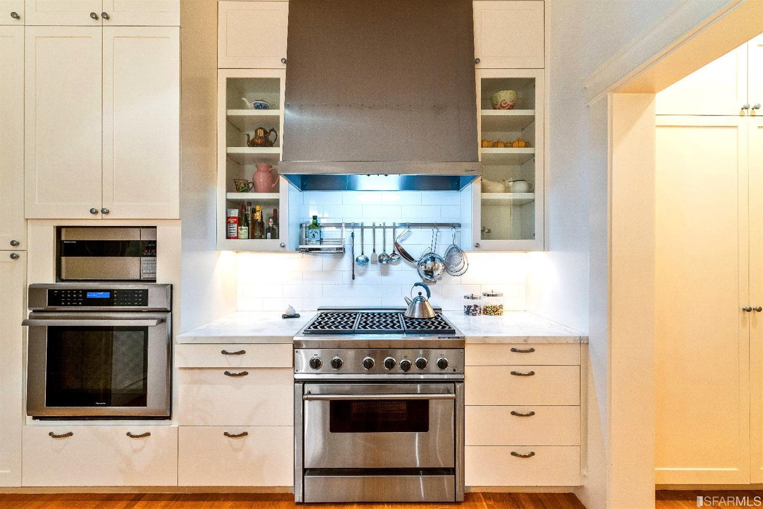 1925 Gough Street, Unit 11 San Francisco, CA 94109 - Photo 18 of 46 a kitchen with stainless steel appliances a stove and a microwave