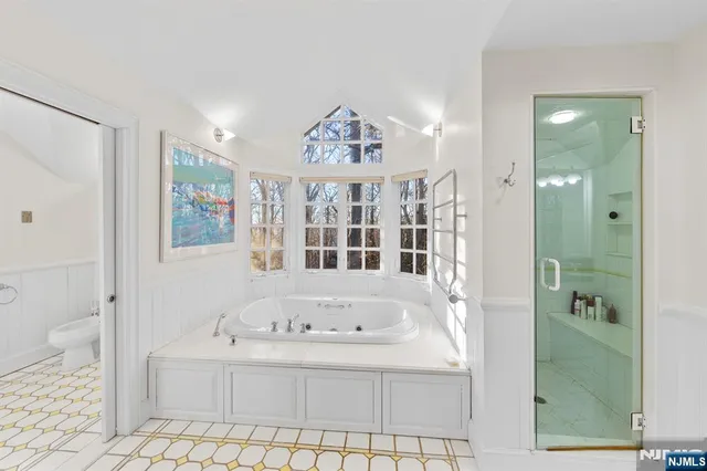 a bathroom with a bathtub and a shower