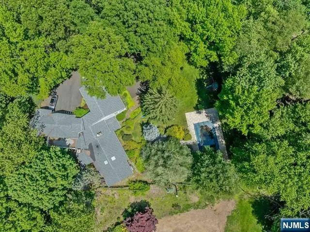 an aerial view of a house with a yard and outdoor seating