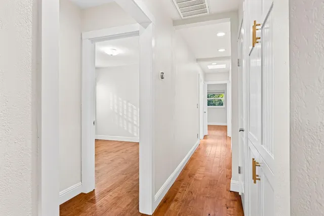 a view of a hallway with wooden floor