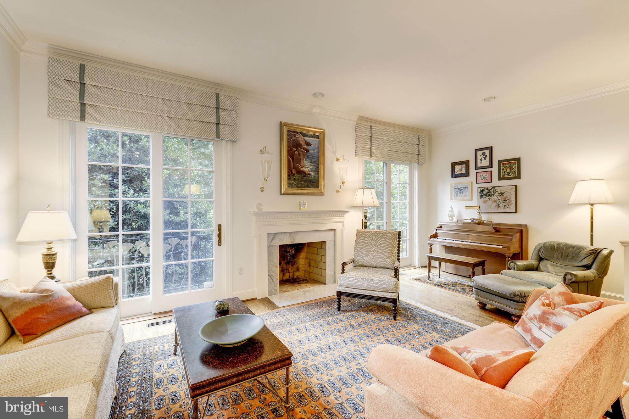 3628 Winfield Lane Northwest Washington, DC 20007 - Photo 3 of 30 Step-down living room with wood burning fireplace
